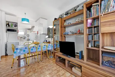 a kitchen with white cabinets and a refrigerator at Casa Dos Netos in Burgau