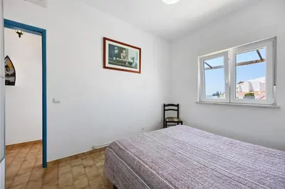 a room with a window with a view of the ocean at Casa Dos Netos in Burgau