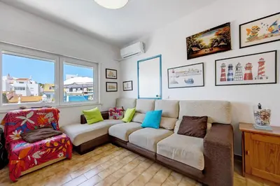 a kitchen and dining room with a table and chairs at Casa Dos Netos in Burgau