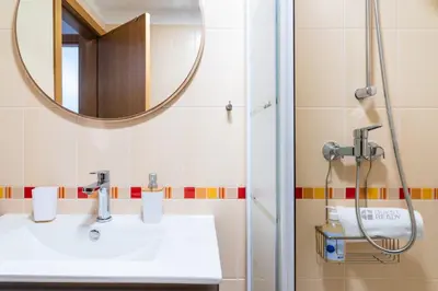 a bathroom with a sink and a mirror at GuestReady - Duplex paradise in Caniço in Caniço