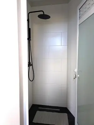 a bathroom with a shower with a glass door at Monte Gordo Accommodation in Ribeira Brava