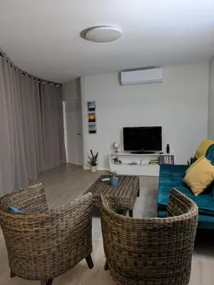a living room with a couch and chairs at Monte Gordo Accommodation in Ribeira Brava