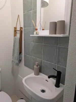 a bathroom with a sink and a mirror at Monte Gordo Accommodation in Ribeira Brava