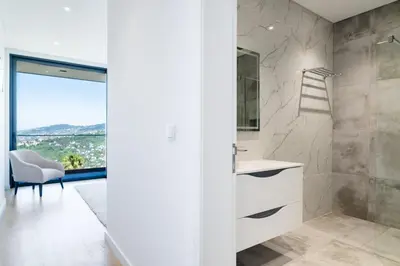 a bathroom with a sink and a shower with a view at GuestReady - Sunset Heaven Villa in Calheta
