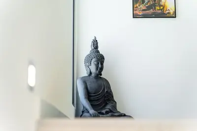 a statue of aitating buddha in a room at GuestReady - Sunset Heaven Villa in Calheta