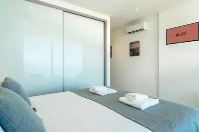 a bedroom with a bed with two towels on it at GuestReady - Sunset Heaven Villa in Calheta