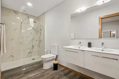 a bathroom with a toilet and a sink and a shower at Casa das Raposinhas IV, Funchal in Funchal