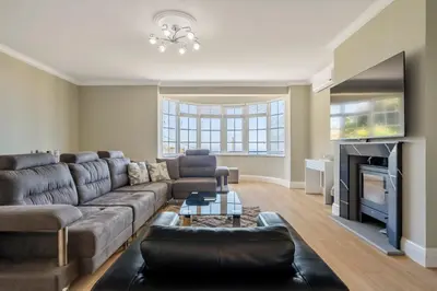 a living room with a couch and a fireplace at Ocean SkyLine in Arco da Calheta