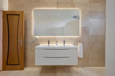 a bathroom with a white sink and a mirror at Ocean SkyLine in Arco da Calheta