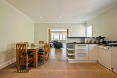 a kitchen with a table and a dining room at Ocean SkyLine in Arco da Calheta