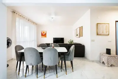 a living room with a dining room table and chairs at R&V Paradise by GALMI in Santa Cruz