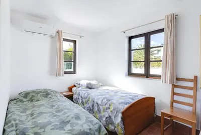 a bedroom with two beds and a window at Luz Home - Three Bedroom Villa in Luz
