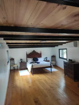 a bedroom with a bed and a wooden ceiling at Little Hideaway in São Vicente
