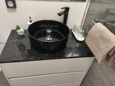 a black sink on a counter in a bathroom at Little Hideaway in São Vicente