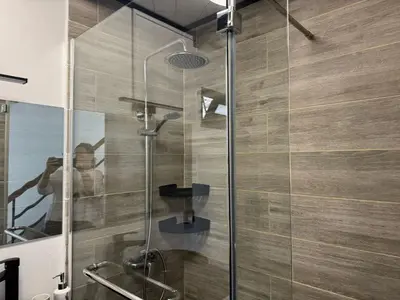 a shower with a glass door in a bathroom at Little Hideaway in São Vicente