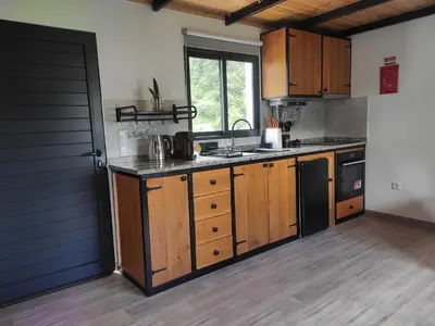 a kitchen with wooden cabinets and a counter top at Little Hideaway in São Vicente