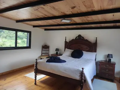 a bedroom with a bed and a wooden ceiling at Little Hideaway in São Vicente