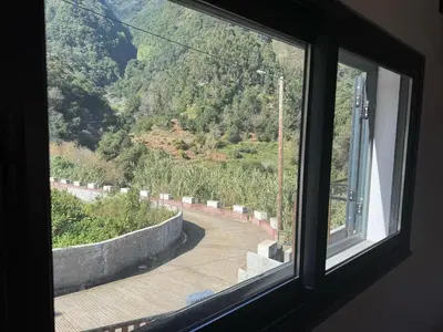 a window with a view of a mountain view at Little Hideaway in São Vicente