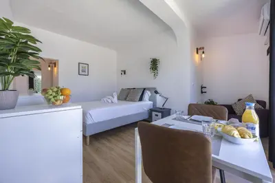 a living room with a bed and a table with a bowl of fruit at Beach Lovers Duplex & Studio by Seewest in Lagos