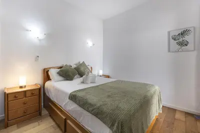 a bedroom with a bed and a night stand with two candles at Beach Lovers Duplex & Studio by Seewest in Lagos
