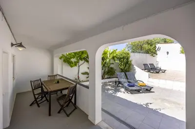a room with a table and chairs on a patio at Beach Lovers Duplex & Studio by Seewest in Lagos