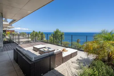 an outdoor patio with a view of the ocean at Lyra Lux Penthouse by LovelyStay in Funchal