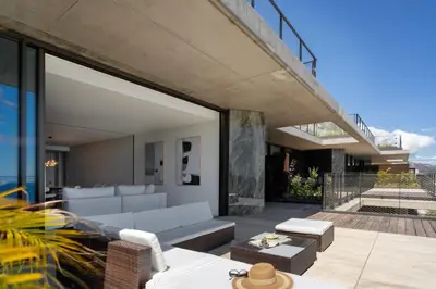 a living room with a couch and a patio at Lyra Lux Penthouse by LovelyStay in Funchal