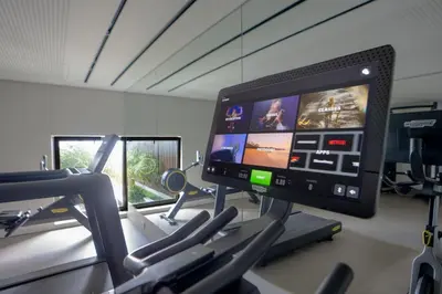 a gym with a computer monitor on a treadmill at Lyra Lux Penthouse by LovelyStay in Funchal