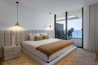 a bedroom with a large bed and a large window at Lyra Lux Penthouse by LovelyStay in Funchal