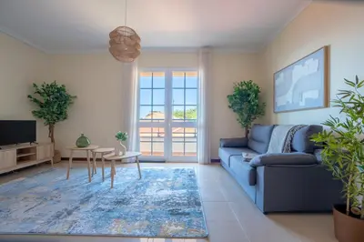 a living room with a blue couch and a tv at Casa das Lajes by LovelyStay in Gaula