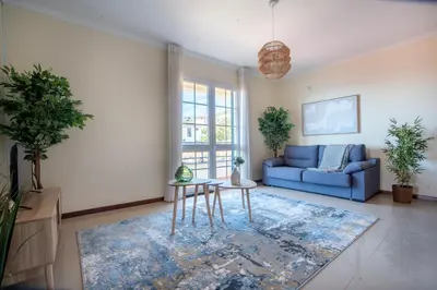 a living room with a blue couch and a table at Casa das Lajes by LovelyStay in Gaula