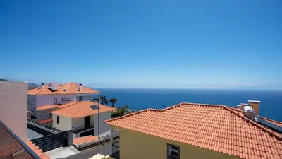 a view of the ocean from the roofs of buildings at Casa das Lajes by LovelyStay in Gaula