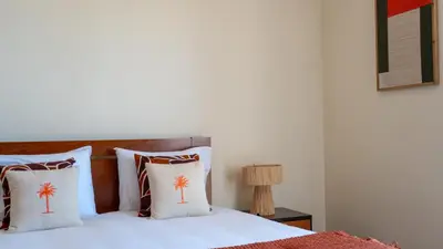 a bed with two pillows with palm trees on it at Casa das Lajes by LovelyStay in Gaula