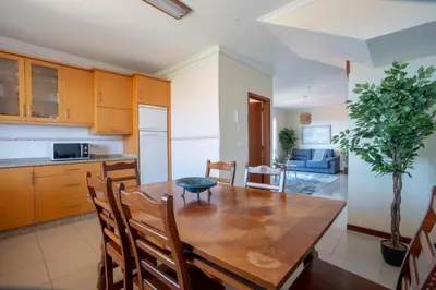 a kitchen and dining room with a wooden table and chairs at Casa das Lajes by LovelyStay in Gaula