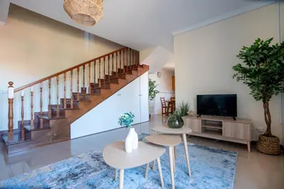 a living room with a staircase and a tv at Casa das Lajes by LovelyStay in Gaula
