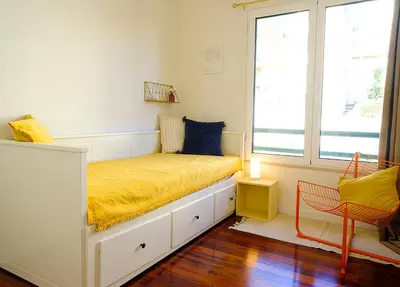 a bedroom with a bed with a yellow blanket at Apartment São Martinho - Caniço in Caniço