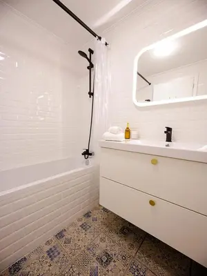 a white bathroom with a sink and a bath tub at Apartment São Martinho - Caniço in Caniço