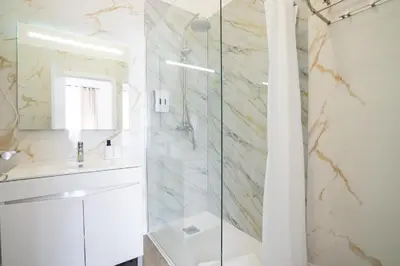 a bathroom with a shower and a sink at Zarco Suites by Sé Funchal in Funchal