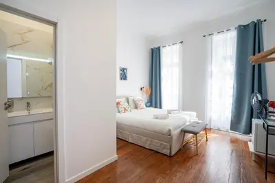 a white bedroom with a bed and a bathroom at Zarco Suites by Sé Funchal in Funchal
