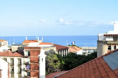 a view of a city with the ocean in the background at Zarco Suites by Sé Funchal in Funchal
