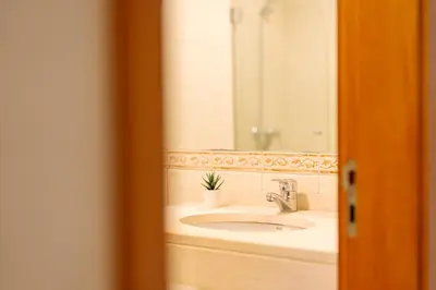a bathroom with a sink and a mirror at Lido Escape in Funchal