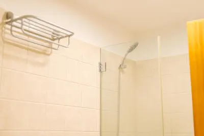 a bathroom with a shower with a shower head at Lido Escape in Funchal