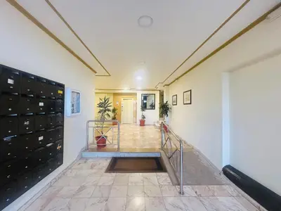 a hallway with lockers and a staircase in a house at Lido Escape in Funchal