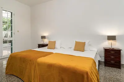 a bedroom with a large bed with a yellow blanket at Casa Carreiro in Paul do Mar