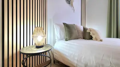 a bedroom with a bed and a table with a lamp at Casa Dama Ana in Caniço