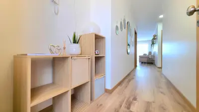 a room with a hallway with wooden shelves and a hallway with a hallway at Casa Dama Ana in Caniço