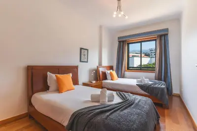 a bedroom with two beds and a window at Views of Madeira by Atlantic Holiday in Ilhéu do Gorgulho