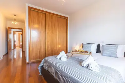 a bedroom with two beds and a wooden cabinet at Views of Madeira by Atlantic Holiday in Ilhéu do Gorgulho