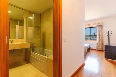 a bathroom with a tub and a sink and a bed at Views of Madeira by Atlantic Holiday in Ilhéu do Gorgulho
