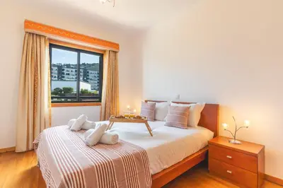 a bedroom with a large bed and a window at Views of Madeira by Atlantic Holiday in Ilhéu do Gorgulho